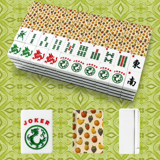 A set of Mahjong-style tiles shown on a plain white background, with a stack of tiles, a few individual tiles visible, and three smaller detail views below. The tiles are white with multicolored fruit and animal motifs, and the back of the tile set has a warm beige background with dense multicolored fruit print.